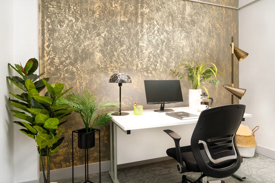 Private office with a gold feature wall and a single desk at the Fern Road offices in Sandyford, Dublin